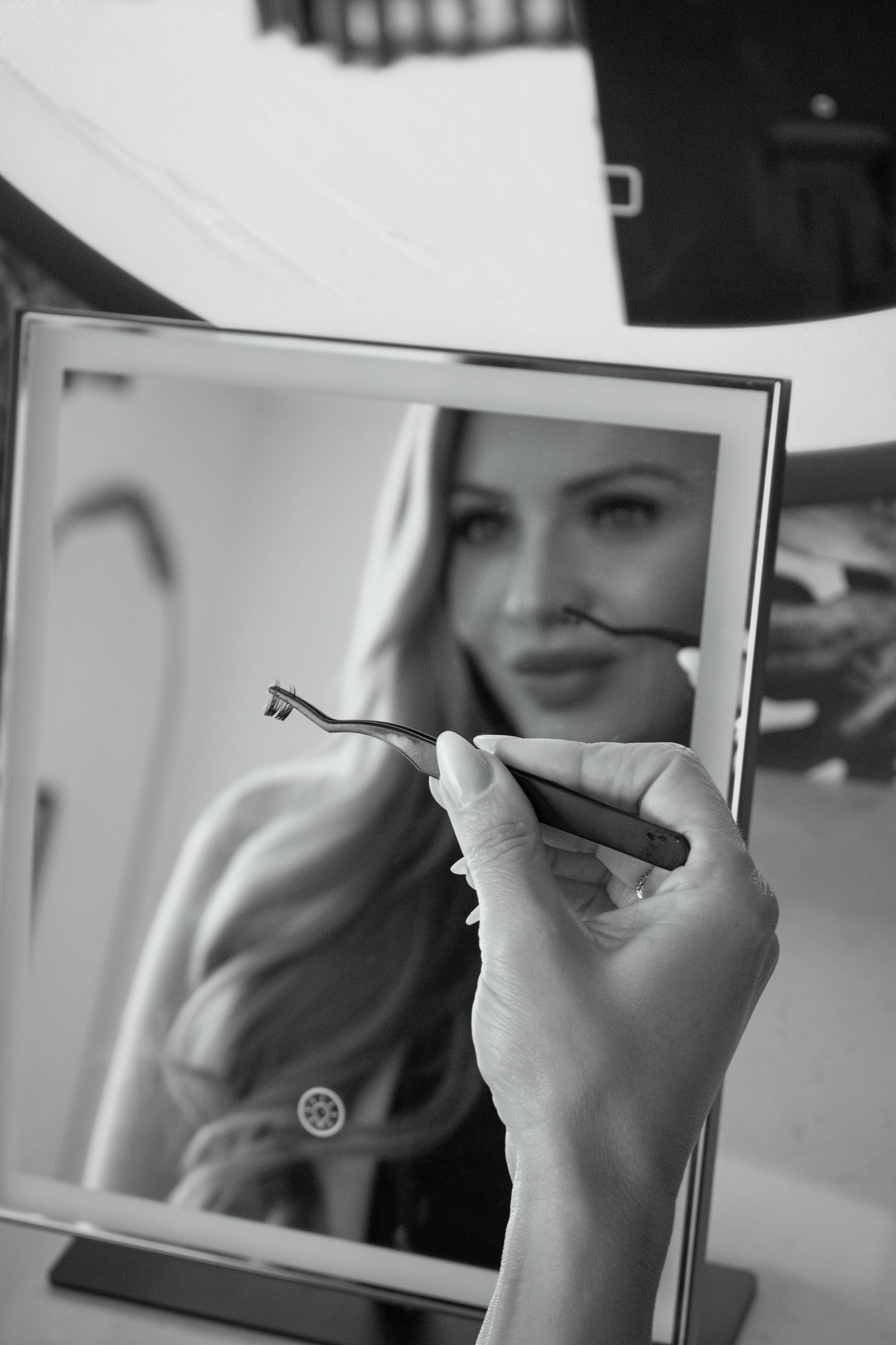Woman applying lash extensions from home